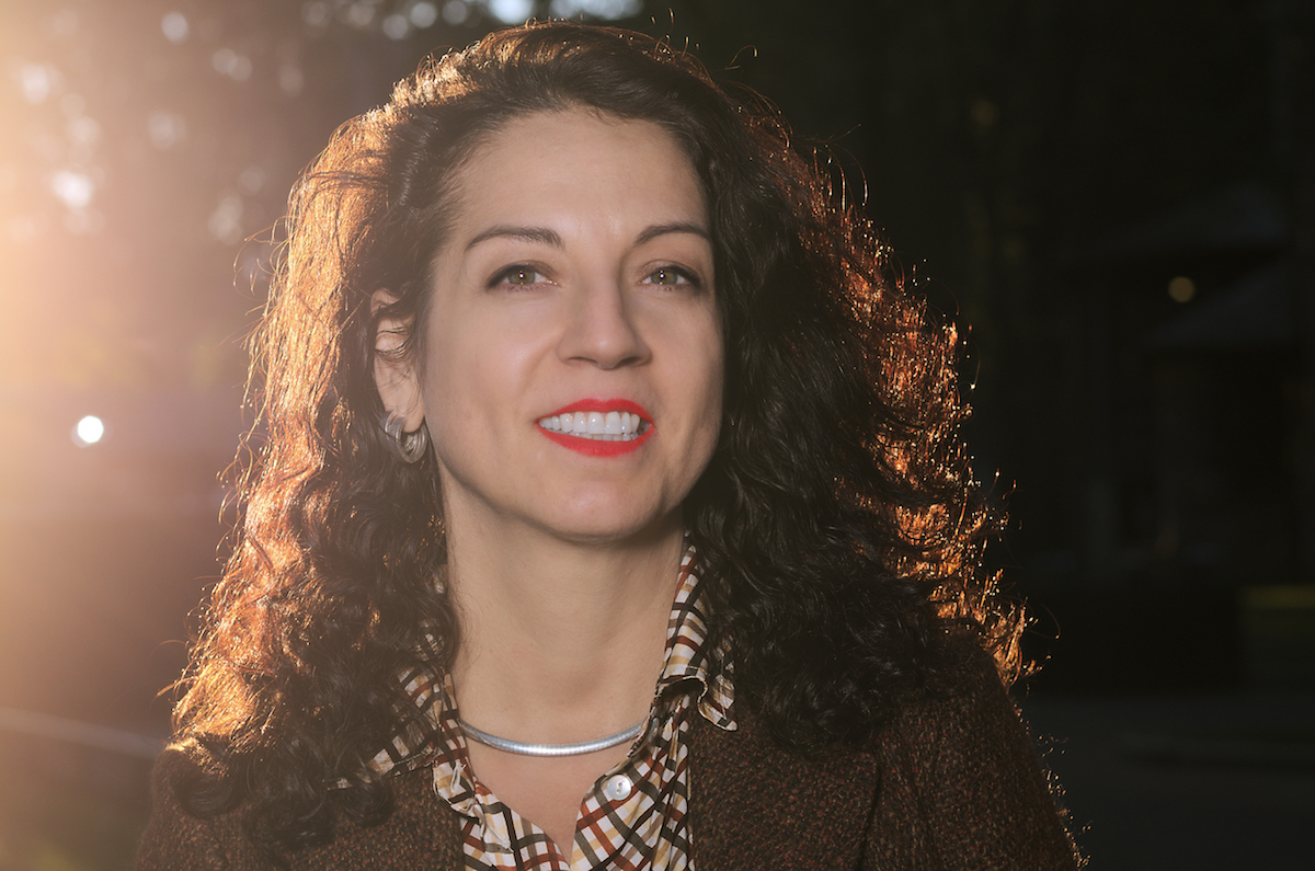 A headshot of a person smiling into the camera