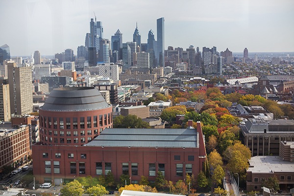 Aerial view of Huntsman Hall and the Philadelphia city skyline in daylight.