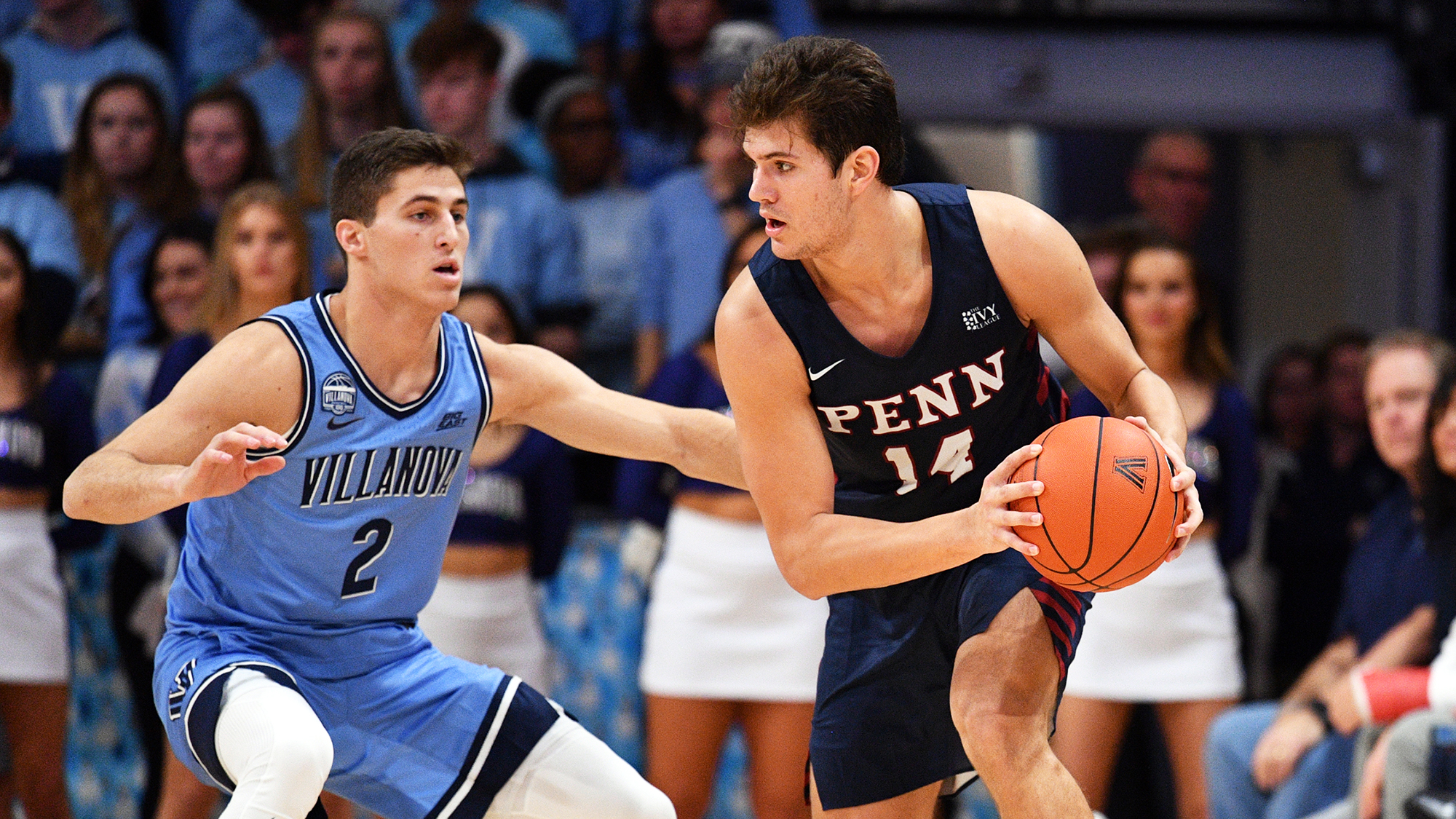 Max Martz of the men's basketball makes a move with the ball while being guarded by a defender during an away game at Villanova.