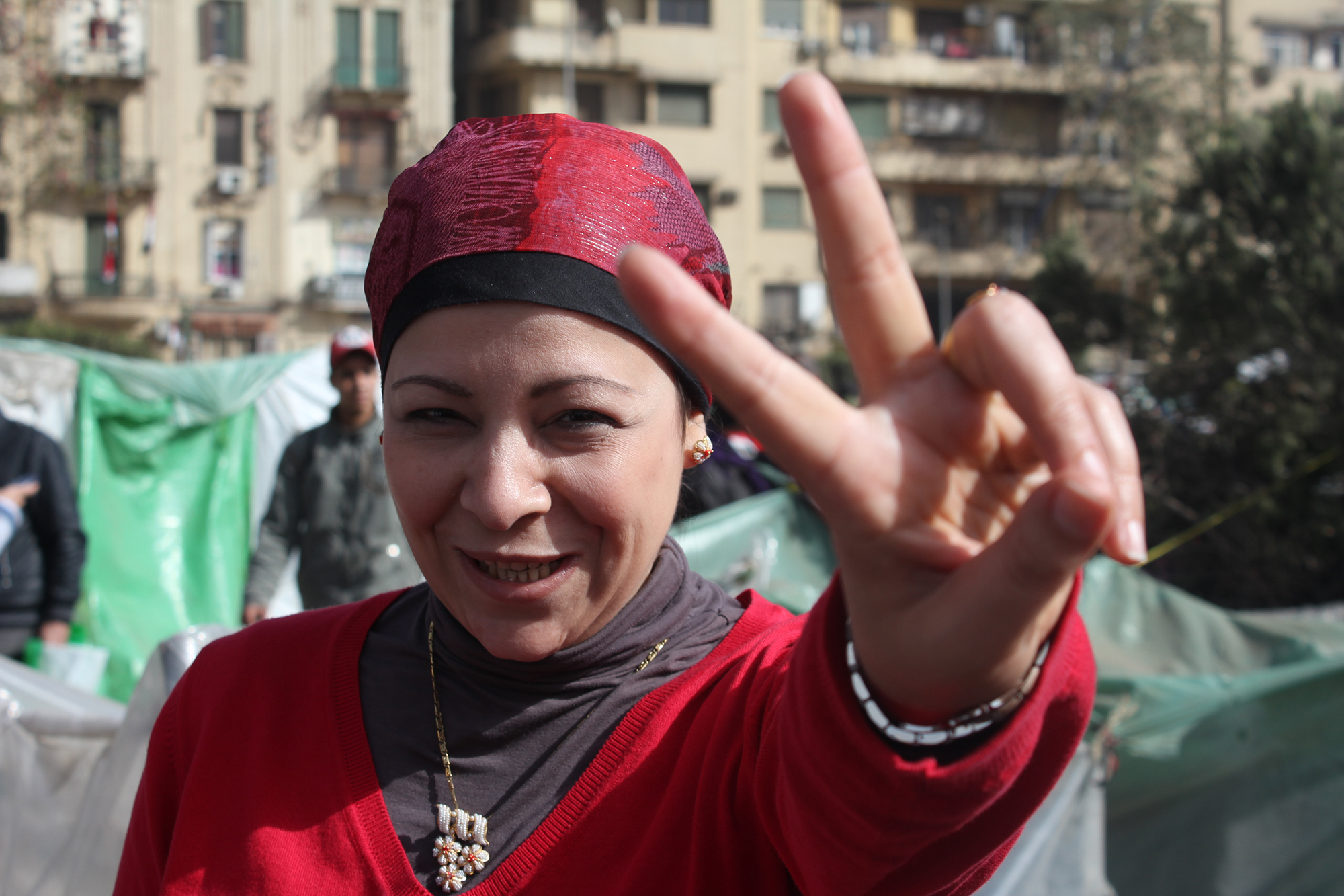 A woman flashes a peace sign at the camera in Egypt