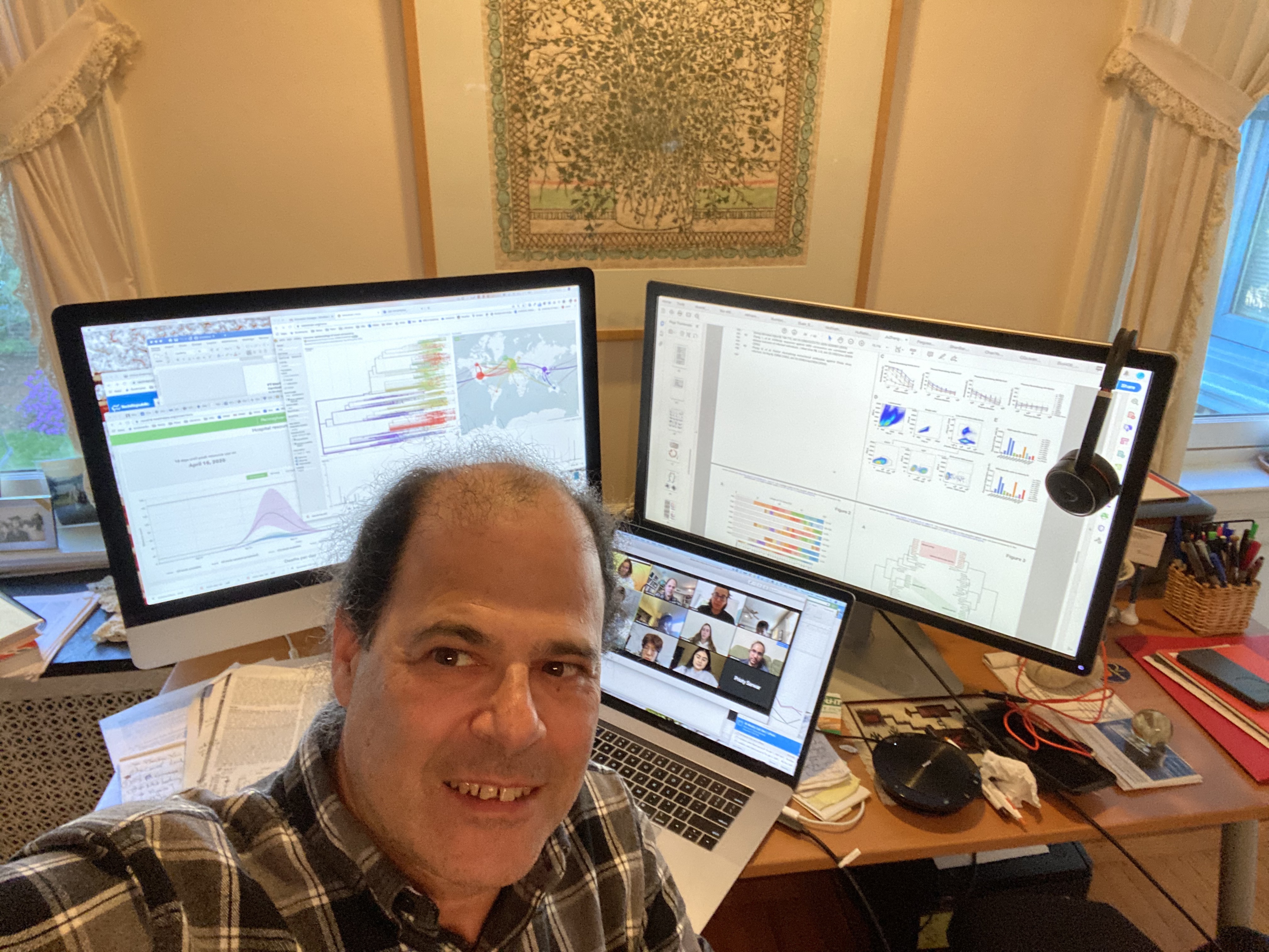 David Roos taking a selfie while teaching a class online, with scientific materials on the screen behind him