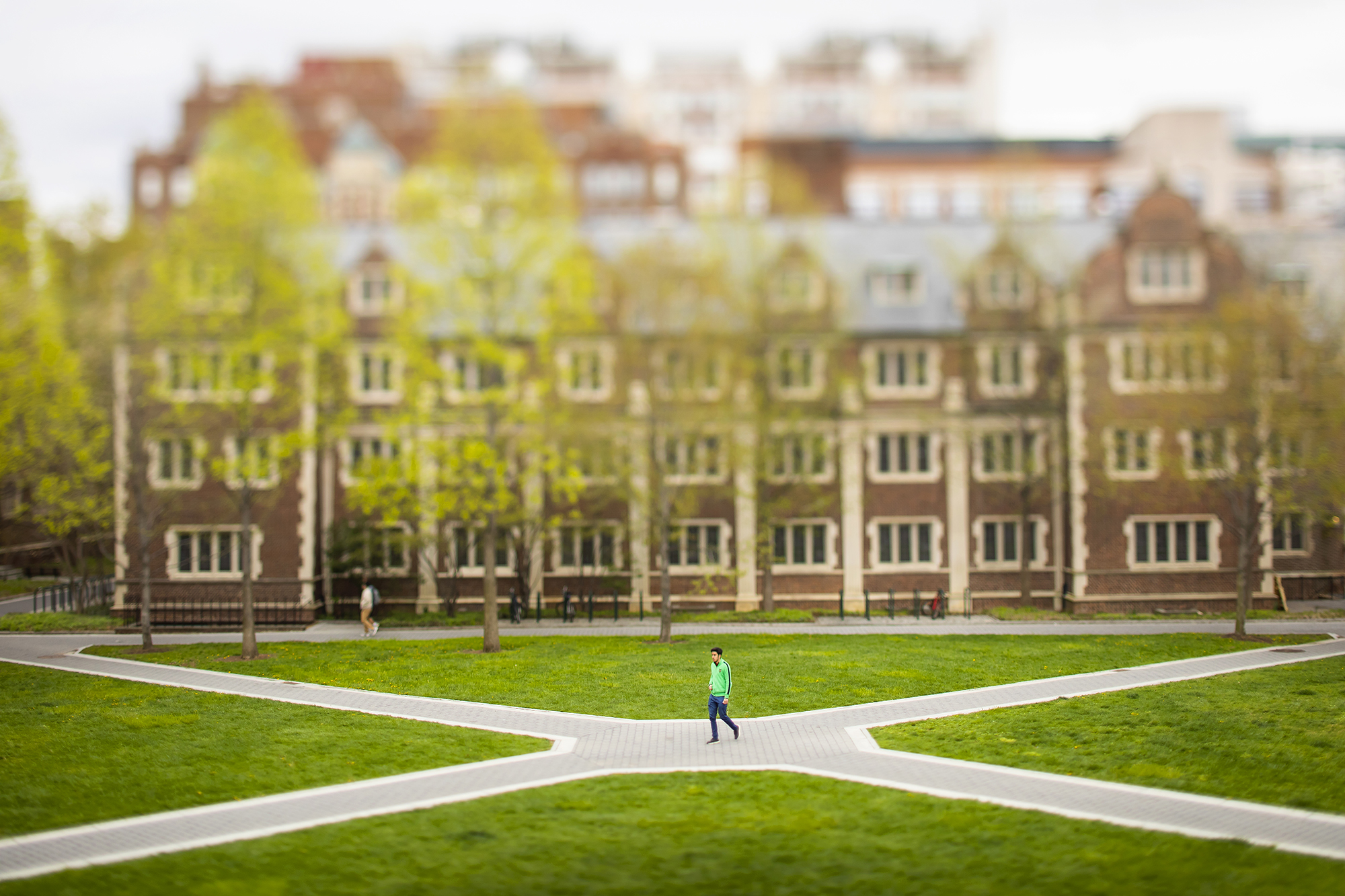 One person walking along the walkway at the Penn Quadrangle outside during the daytime