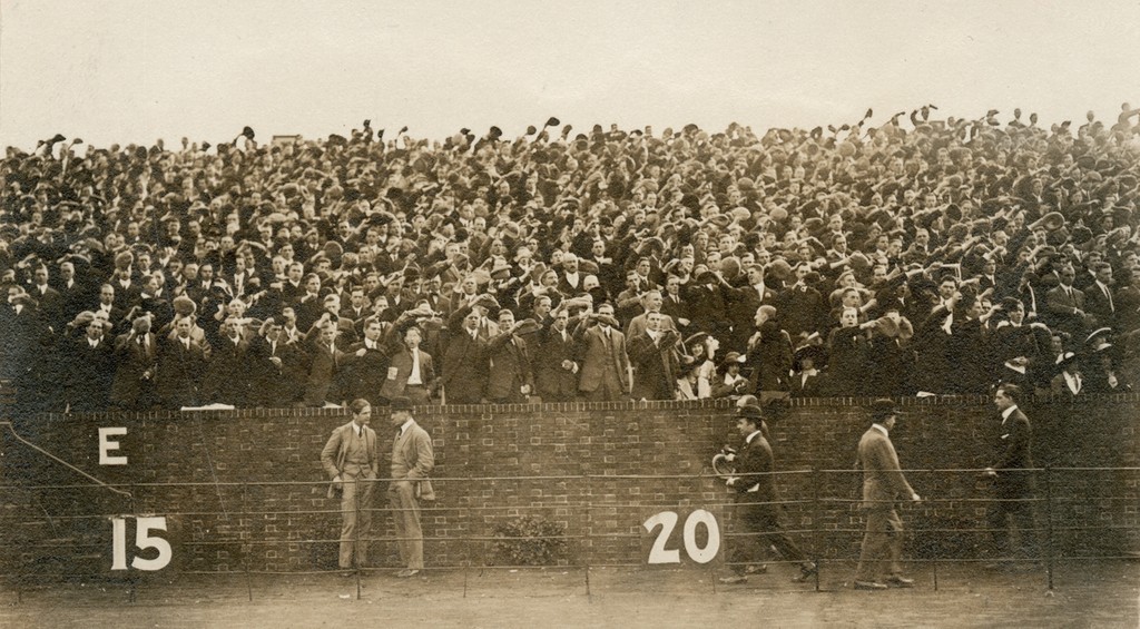 Crowd at football game waving arms