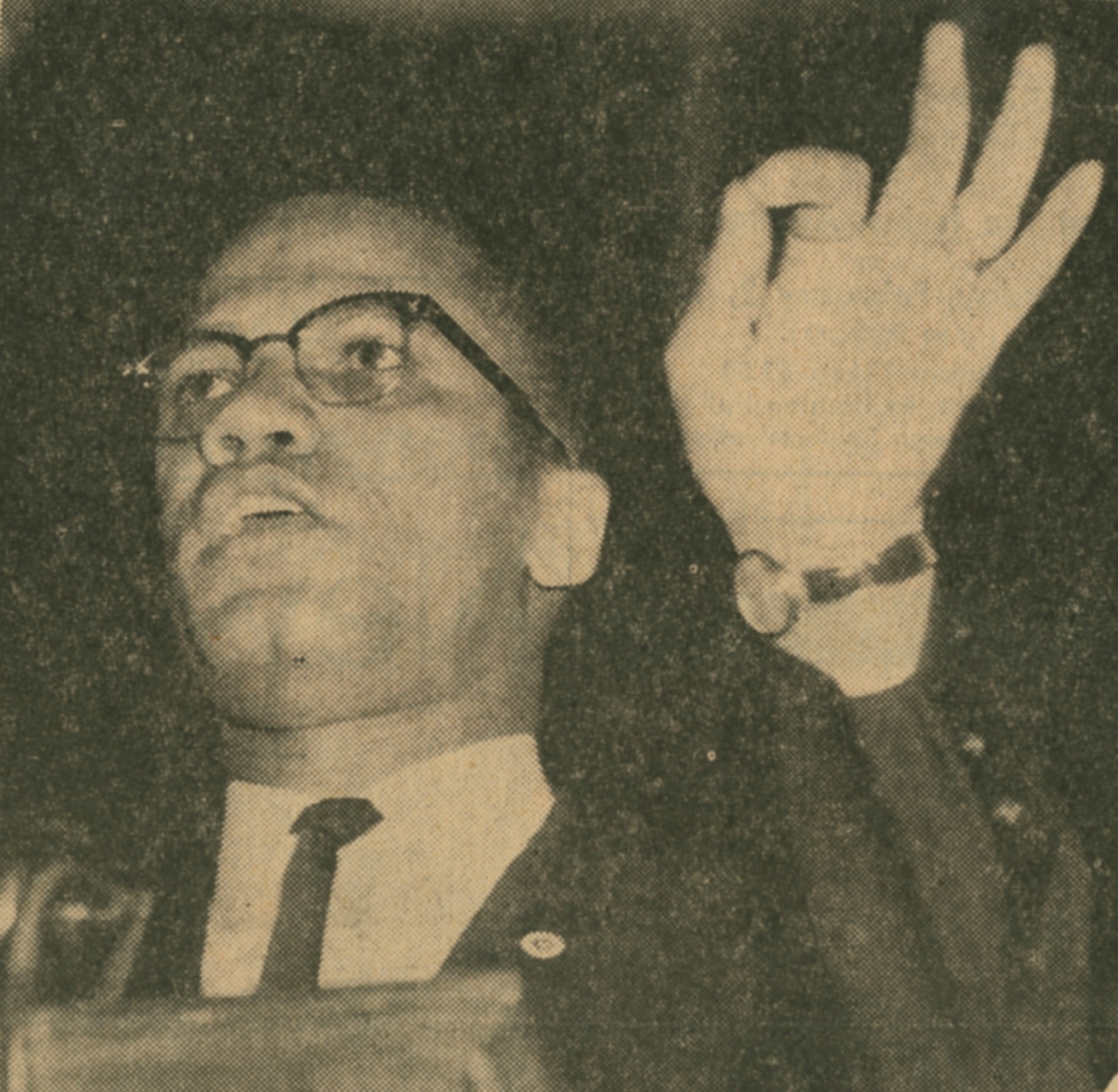 Dressed in a suite and tie, Malcolm X speaks in Irvine Auditorium in January of 1963.