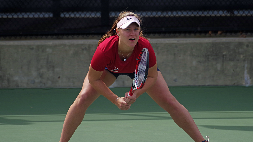 Iuliia Bryzgalova prepares to receive the serve during a tennis match.