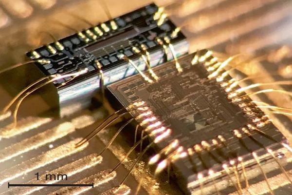 microscopic laser seen closeup, with a 1 milimeter measure for scale