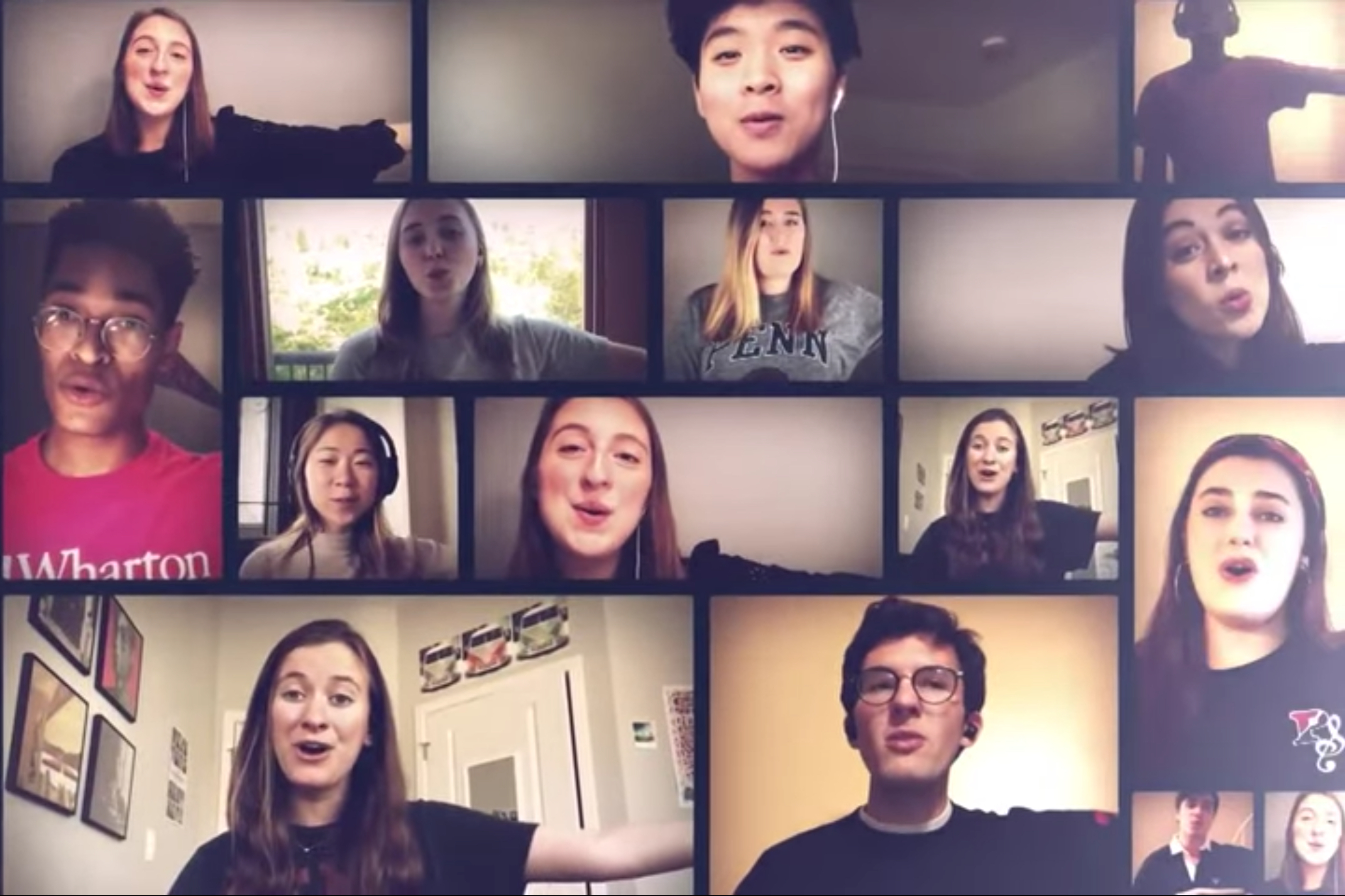 Fifteen students singing in a music video.