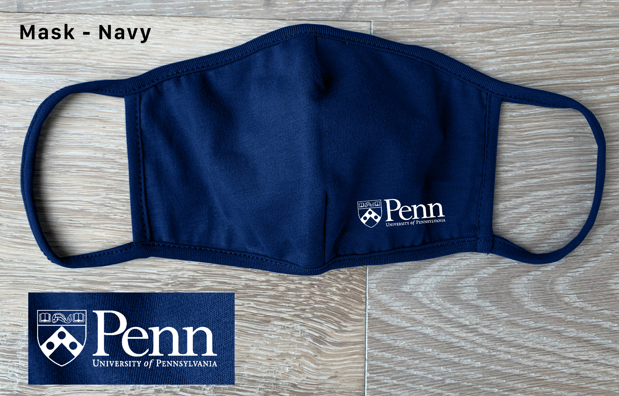 Blue face covering with Penn logo on it