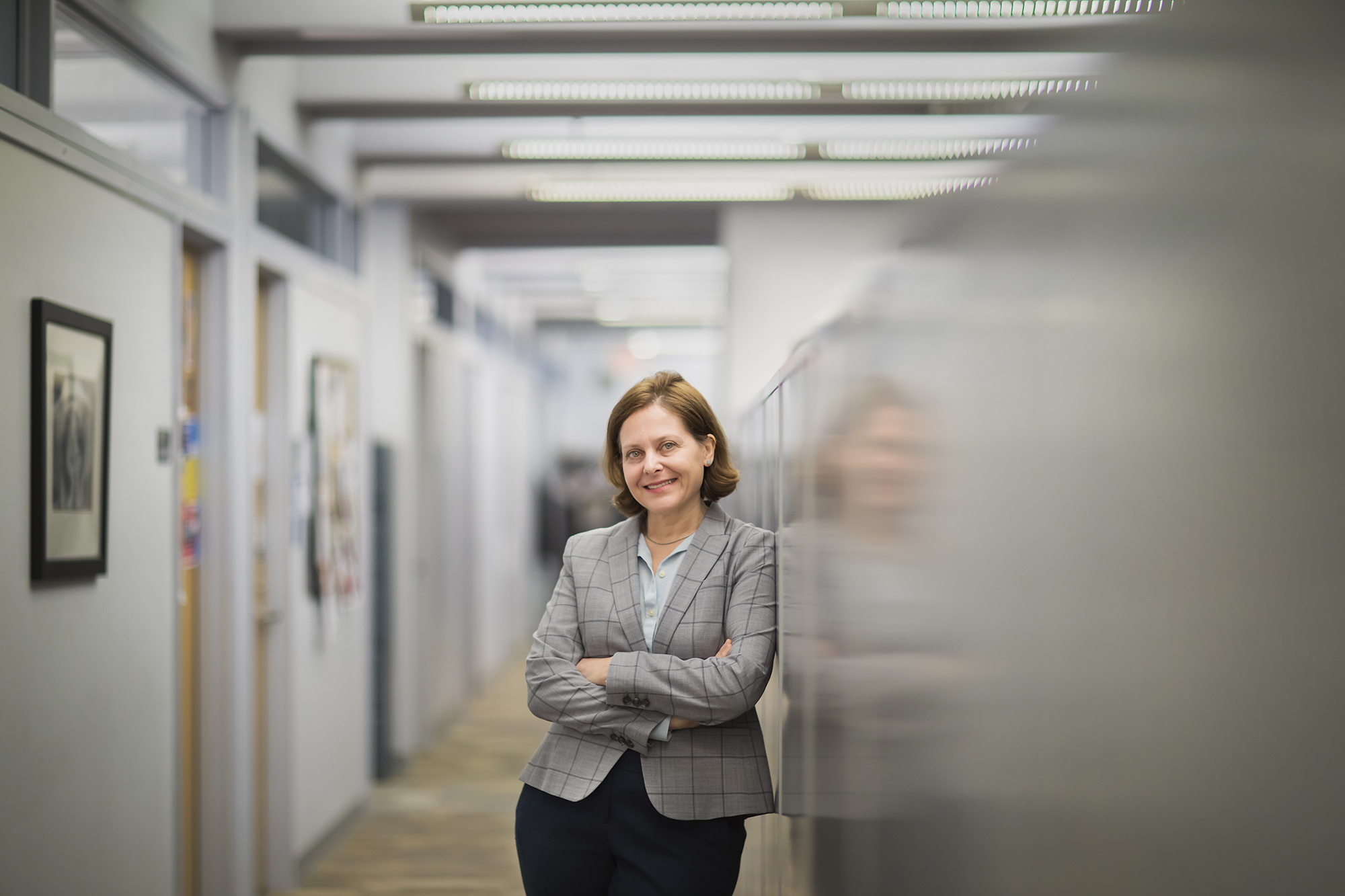 Sigal Ben-Porath of the Graduate School of Education poses in a hallway with her arms folded.