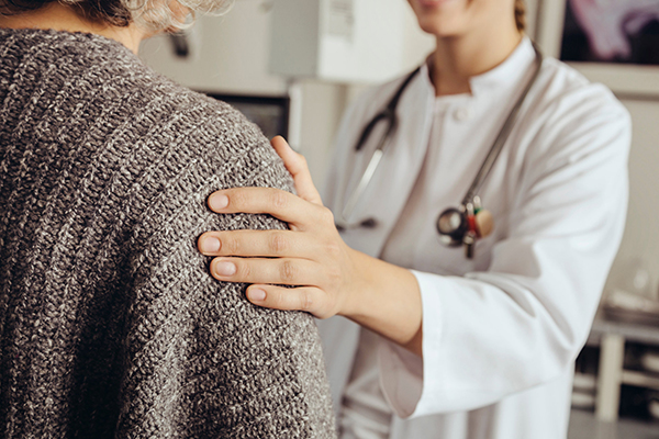 doctor in white coat tending to a patient