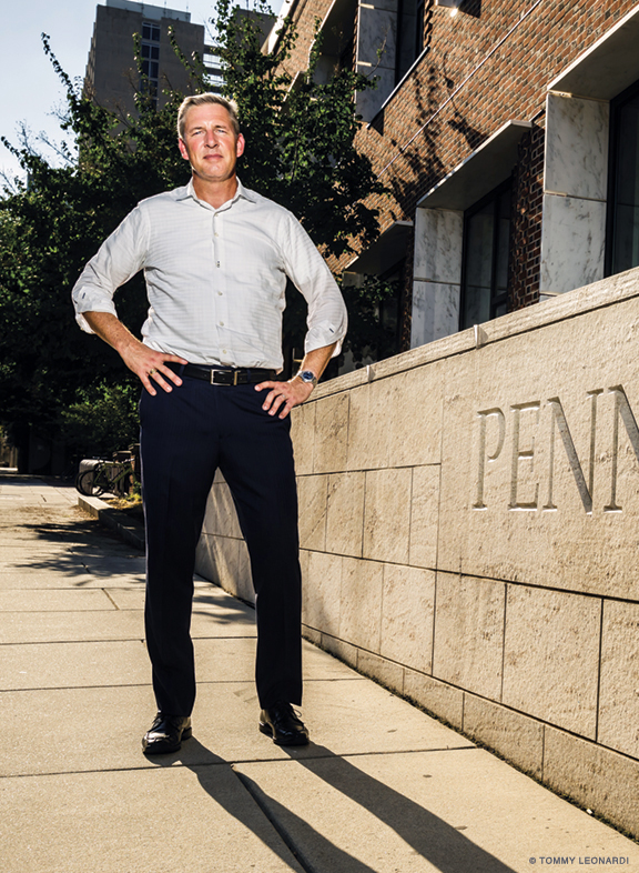 John Holloway standing on sidewalk outside a Penn building in daylight