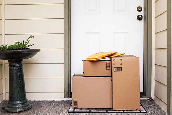 picture of delivery boxes and packages stacked at a residential door