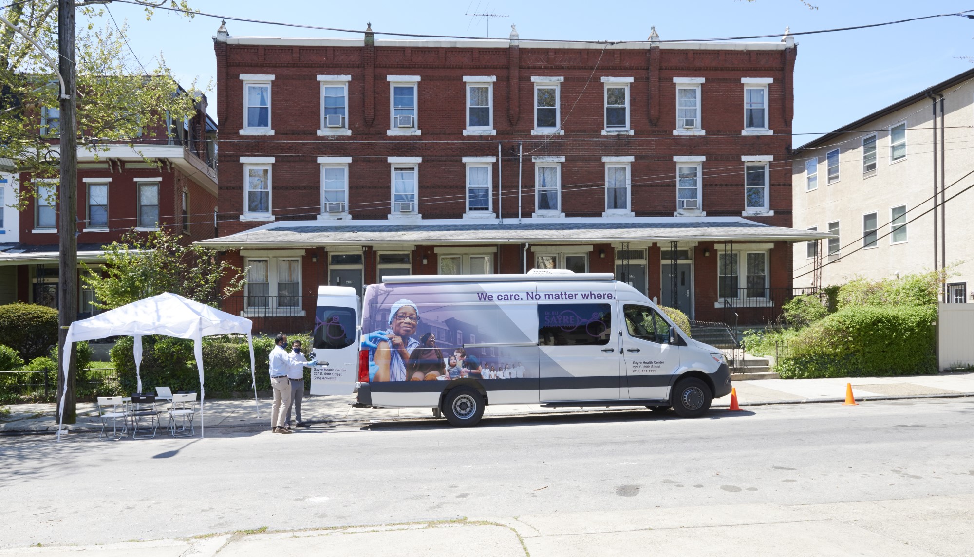 Sayrue Mobile Clinic parked in front of homes
