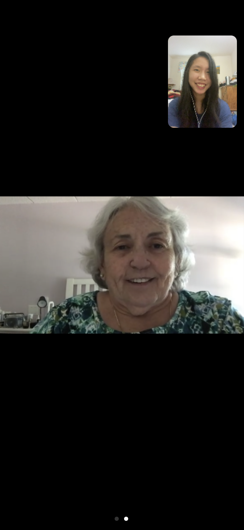 Screenshot of a video call with two people smiling