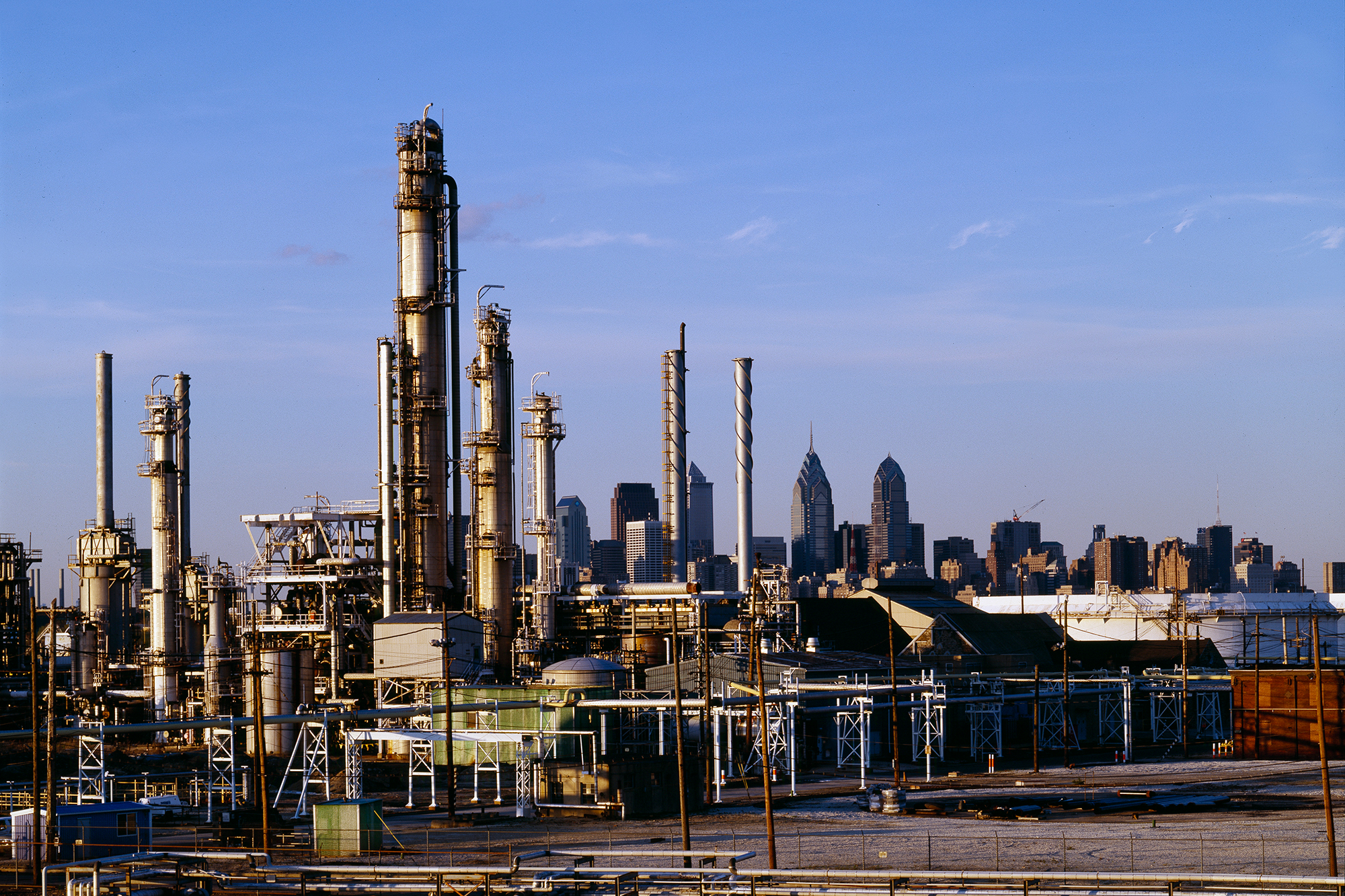 the philadelphia energy solutions refinery with the philadelphia skyline in the background