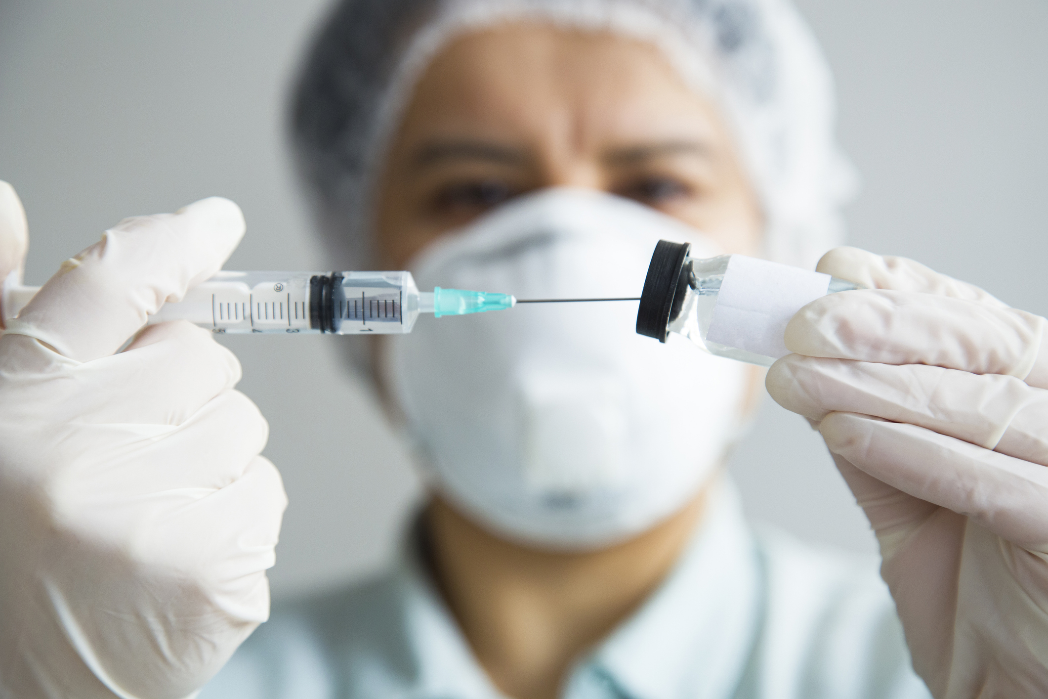 healthcare professional with syringe and vaccine