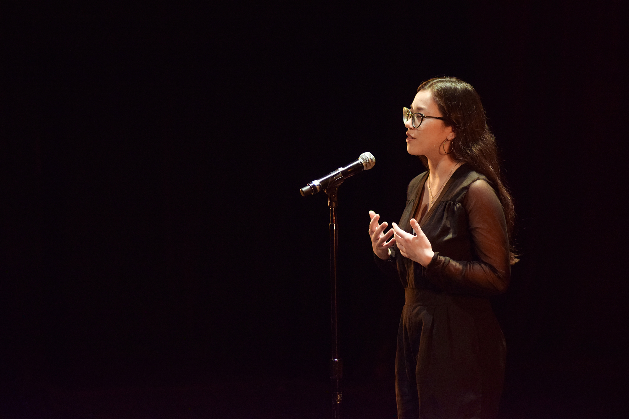 Ollie Kim Dupuy speaking into a microphone.