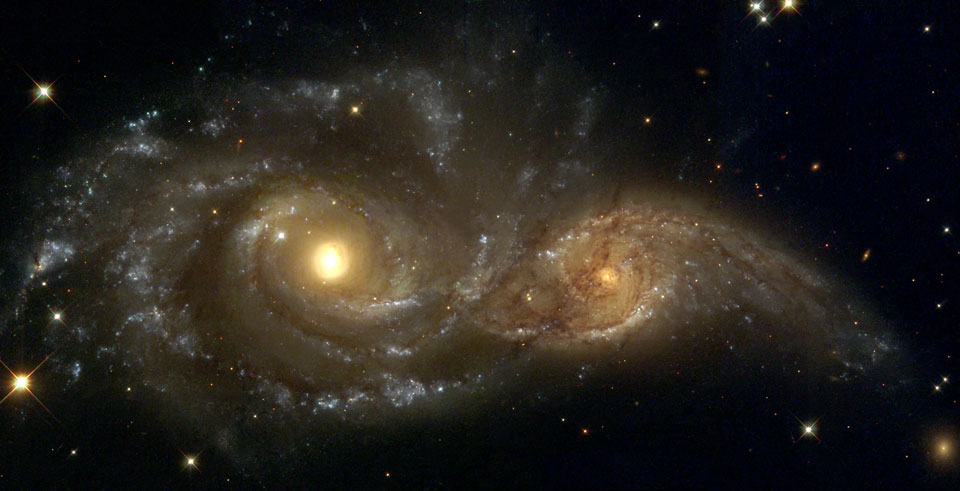 two spiral galaxies merging together