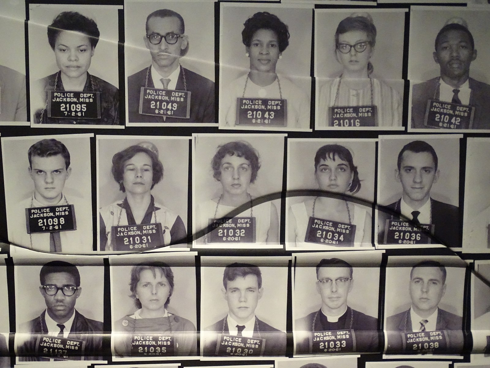 Historical mugshots of 15 people wearing signs around their necks that say, "Police Dept. Jackson, Miss., 7.2.61" along with prison identification numbers