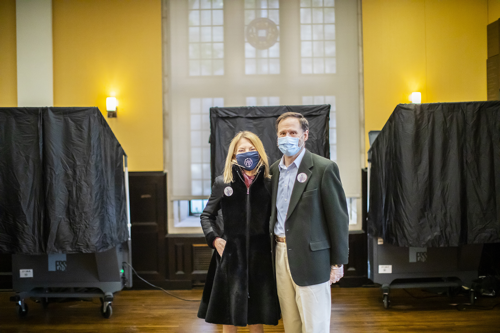 Gutmann and Doyle, both wearing face masks, pose for a photo inside Houston Hall polling place
