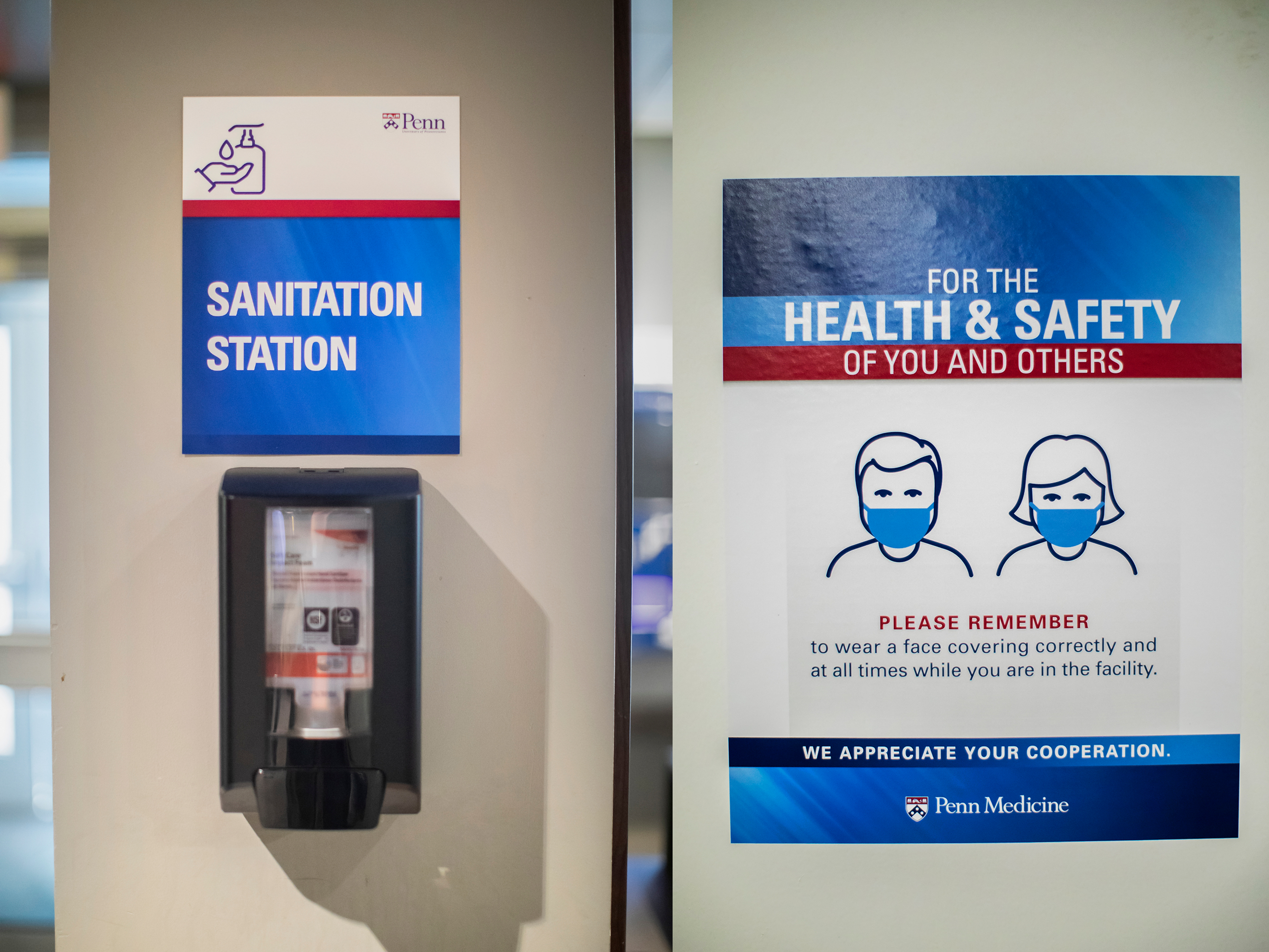 a sanitation station sign above a dispenser of hand sanitizer next to another sign that reads for the health and safety of you and others, please remember to wear a face covering correctly and at all times while you are in the facility, we appreciate your cooperation