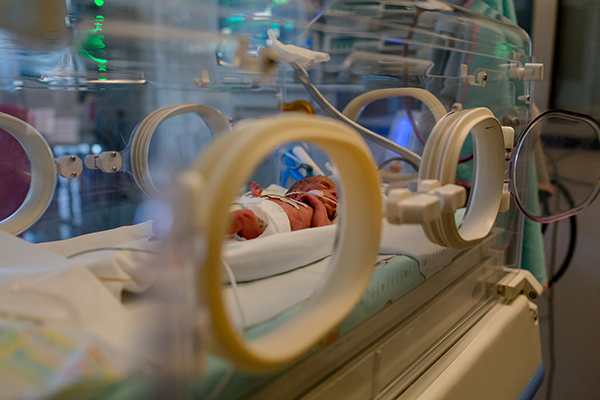 Premature baby in an incubator in the ICU.