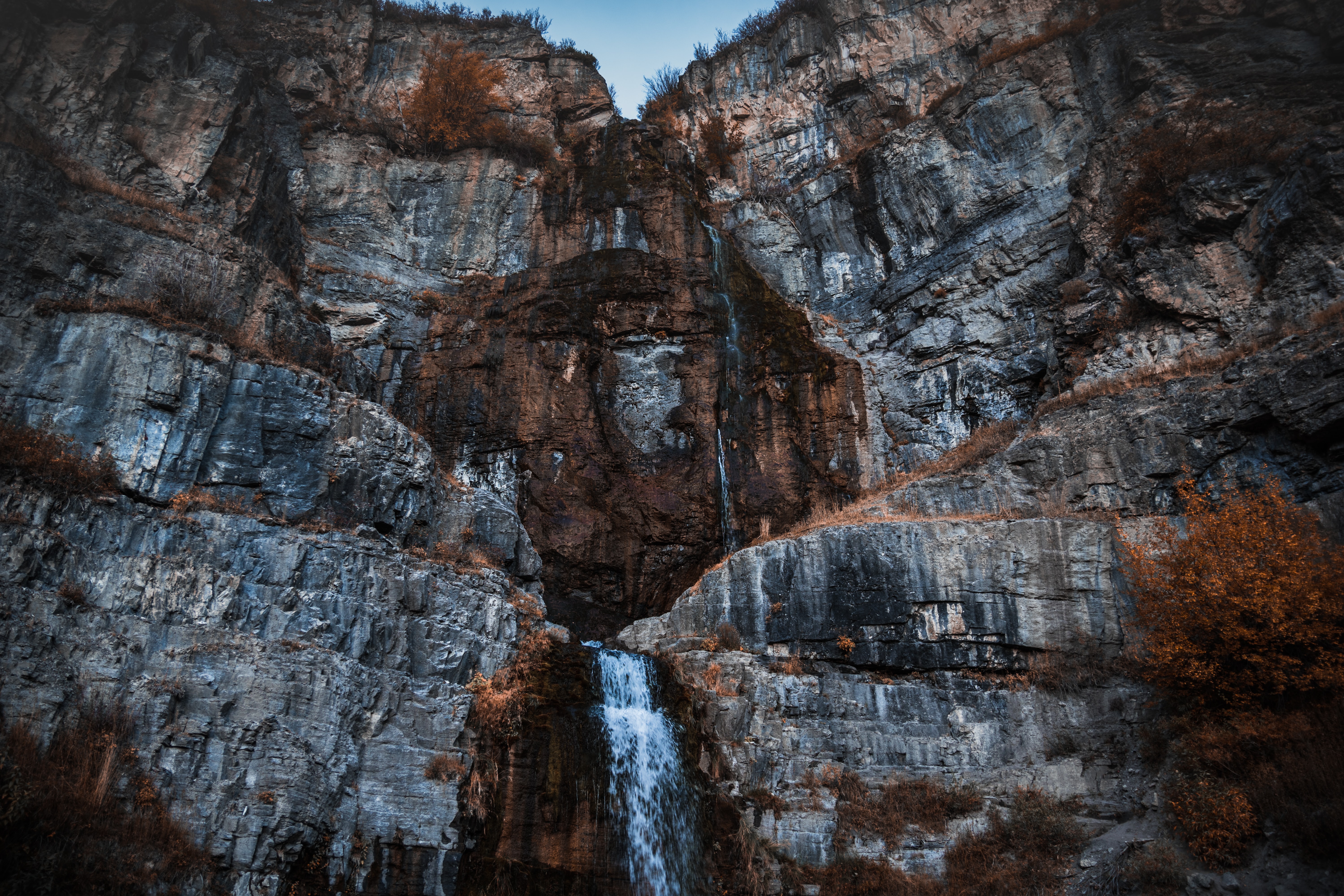 Mountain face with waterfall cascade