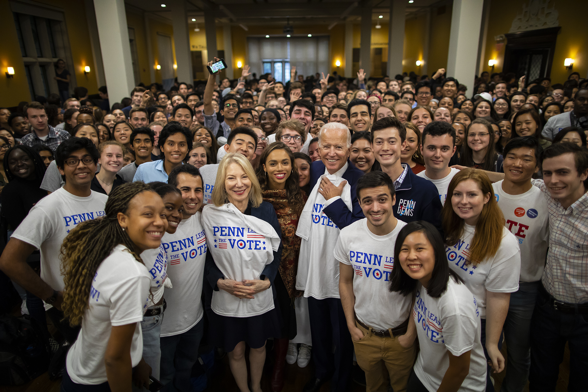 Biden smiles for a photo with a big group of students in Penn Leads the Vote