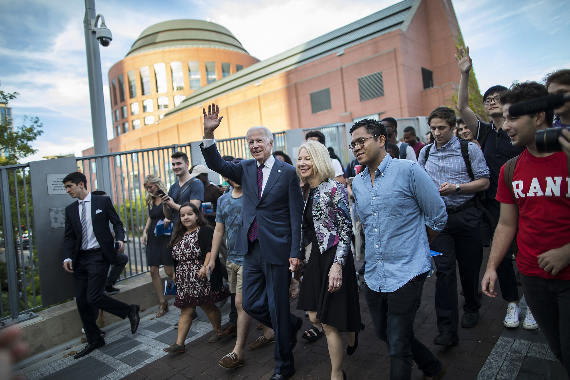 Biden waves on Locust Walk with students following close behind