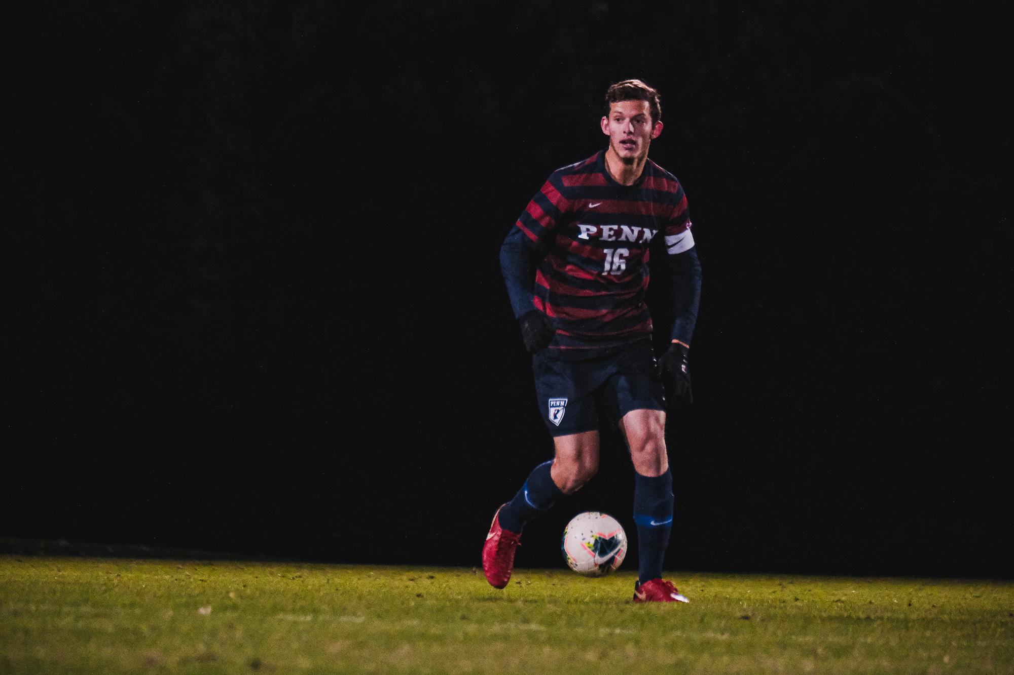 Alex Touche kicks the ball up the field against Princeton.