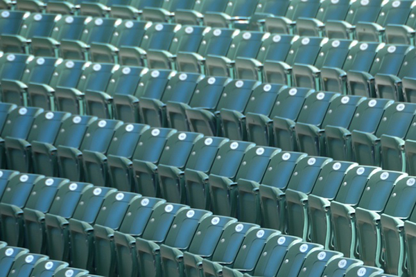 Empty stadium seats indicating no spectators at a sporting event.