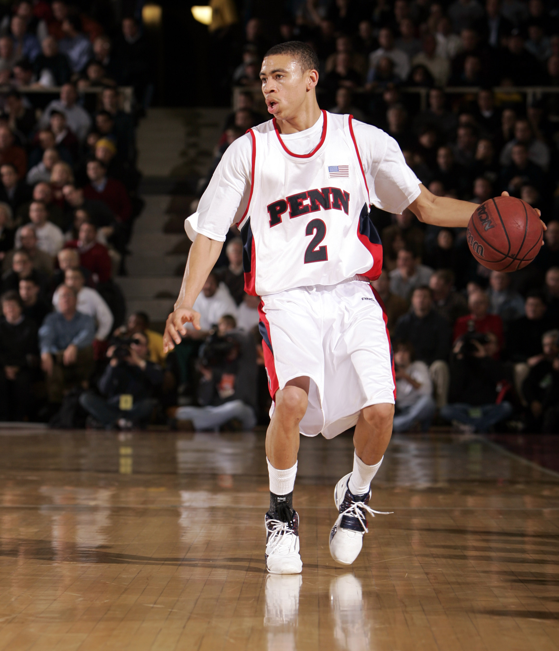 Ibrahim Jaaber dribbles the ball up the court at the Palestra, wearing his white number two Penn jersery.