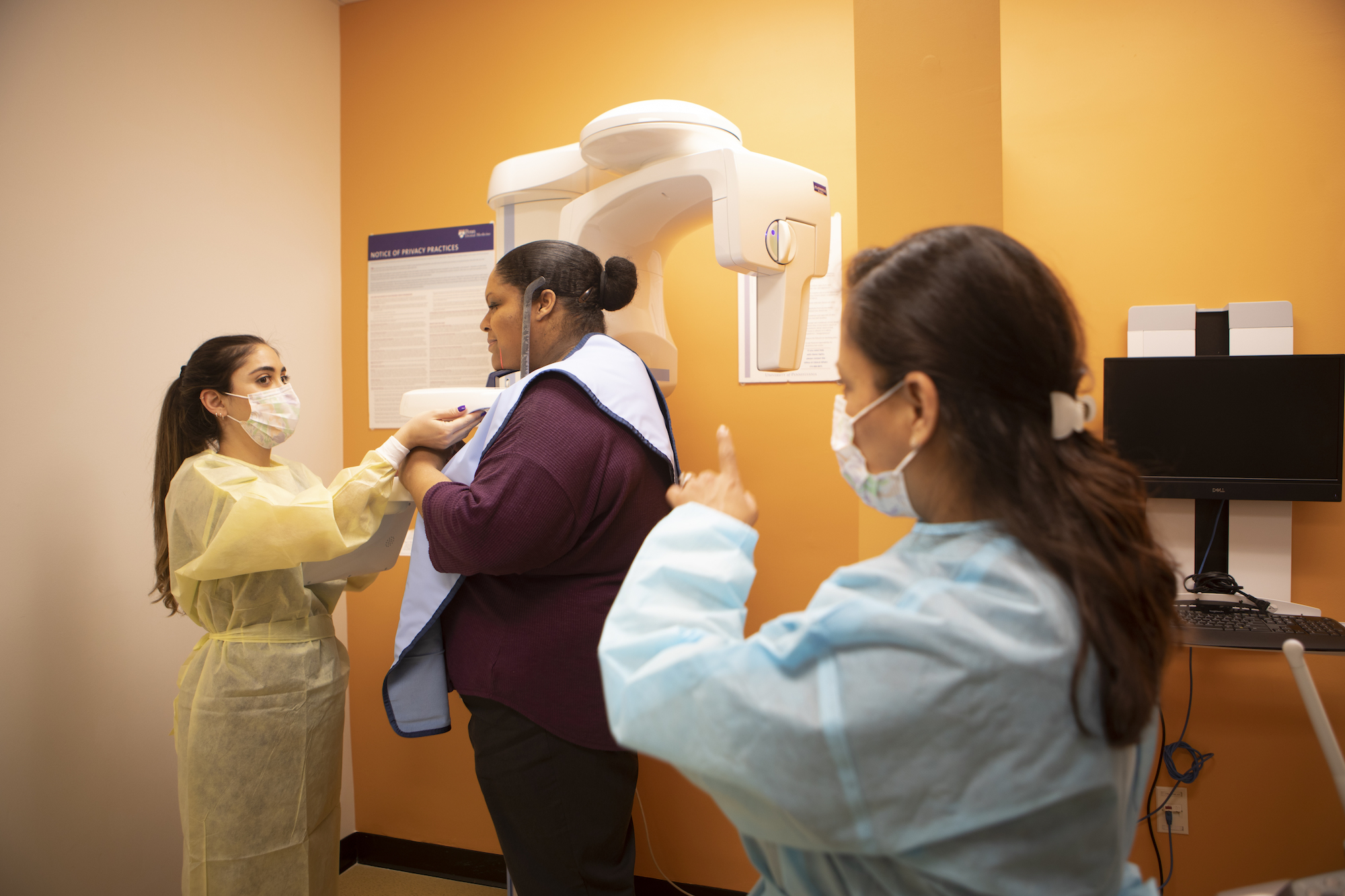 Dental professionals prepare a patient to get oral xrays