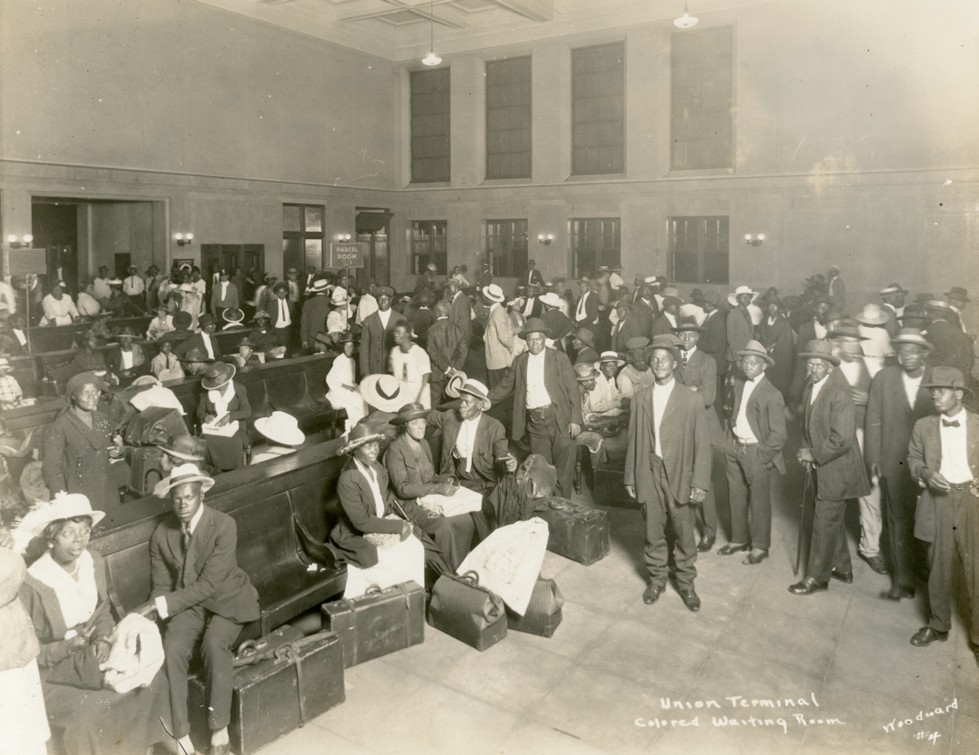 African Americans gather in a segregated waiting area at a train station