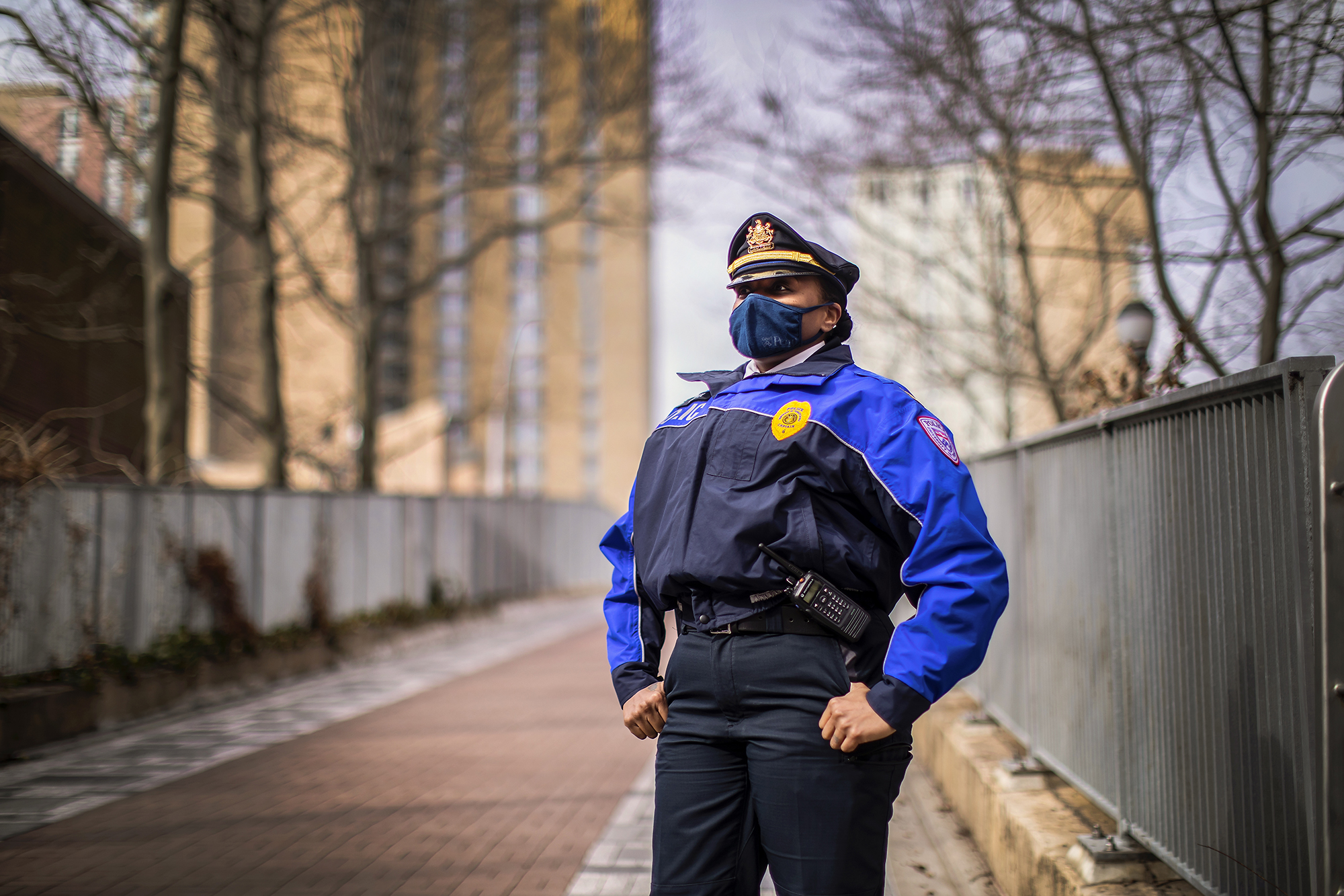 picture of Captain McCoy standing on Penn campus wearing a face covering in police uniform