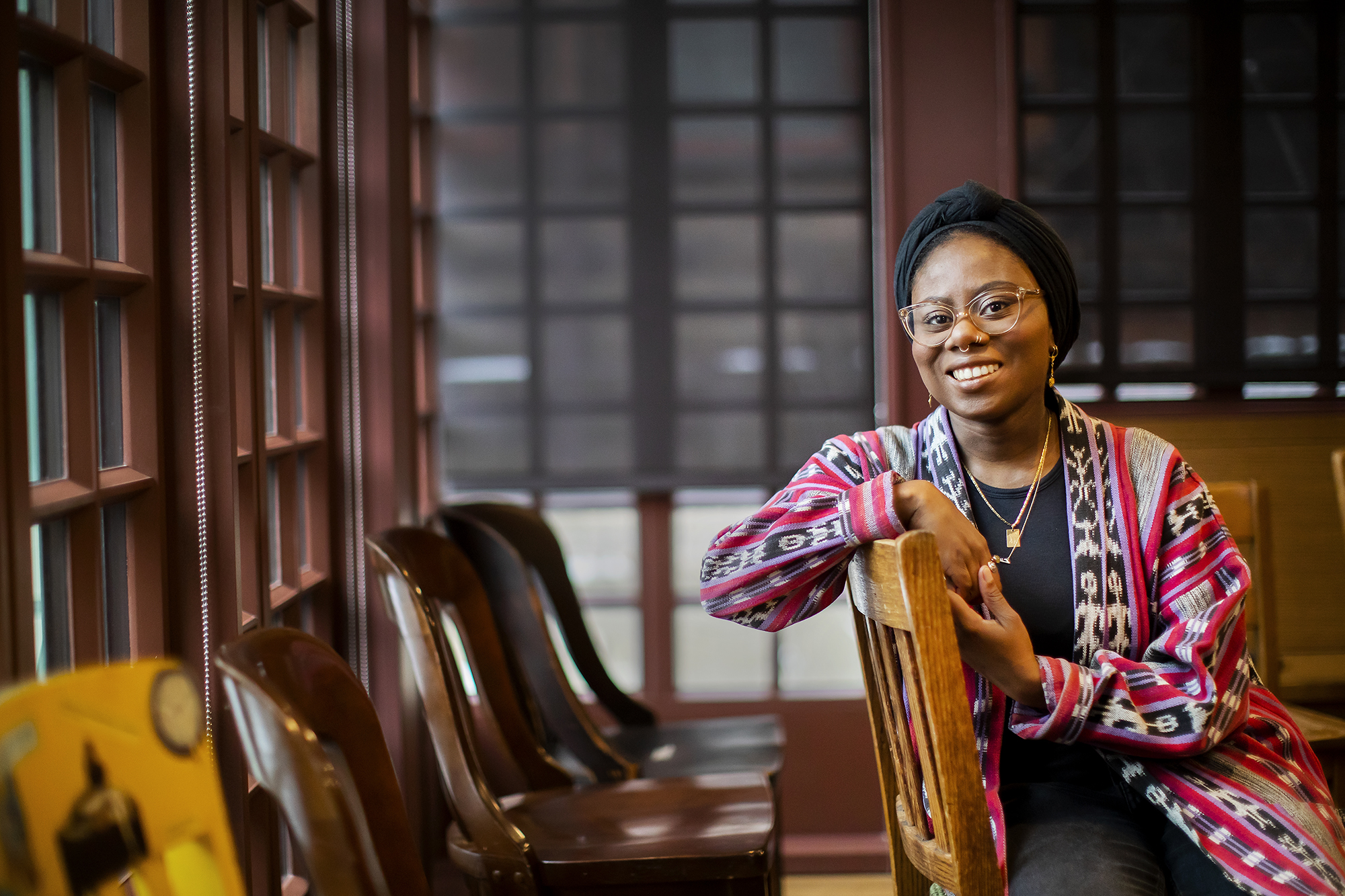 Student sitting in wooden chair.