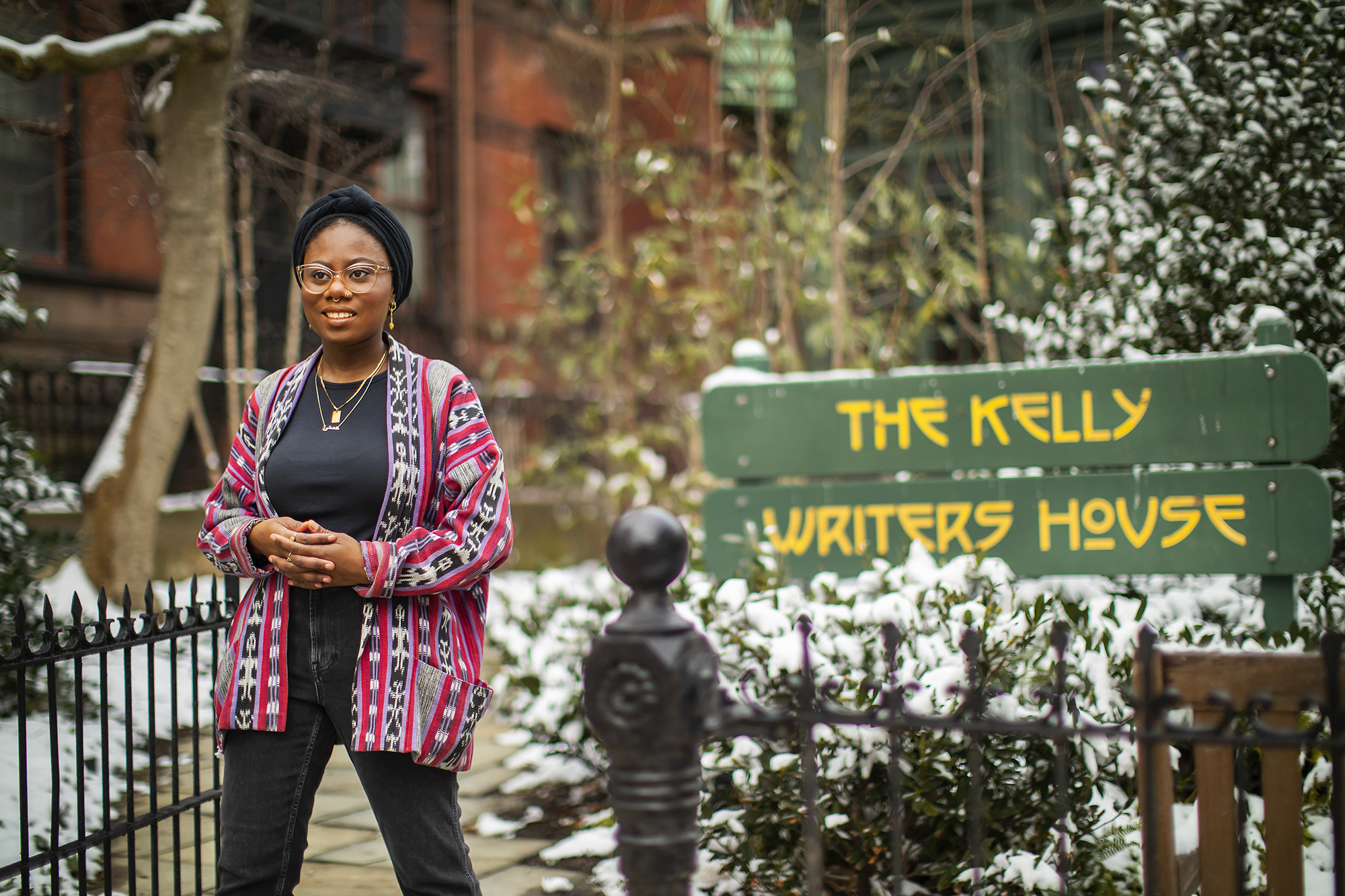 Student standing in front of The Kelly Writers House sign