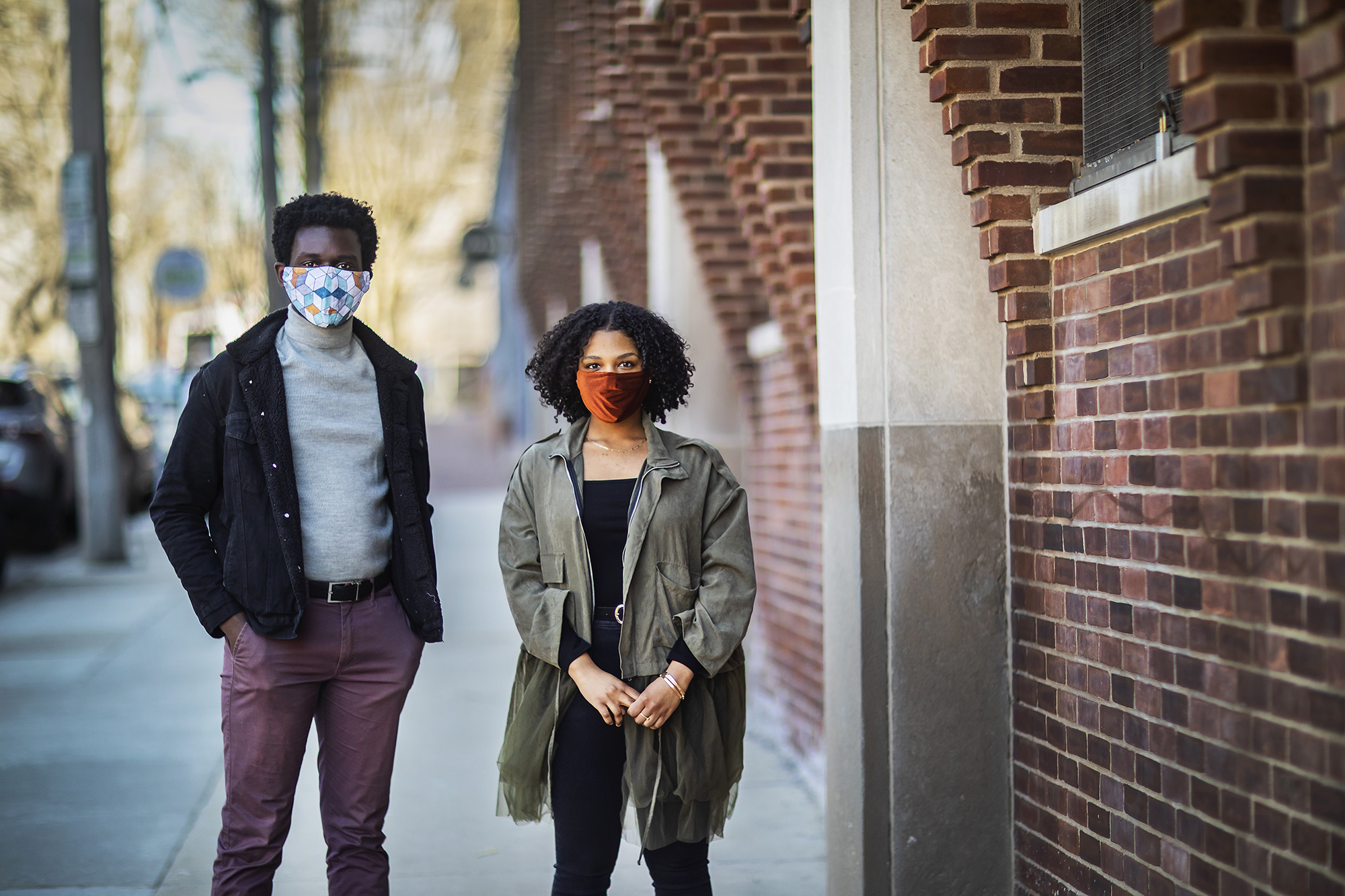 Kwaku Owusu and Mckayla Warwick standing on a sidewalk on Penn’s campus wearing face masks. 