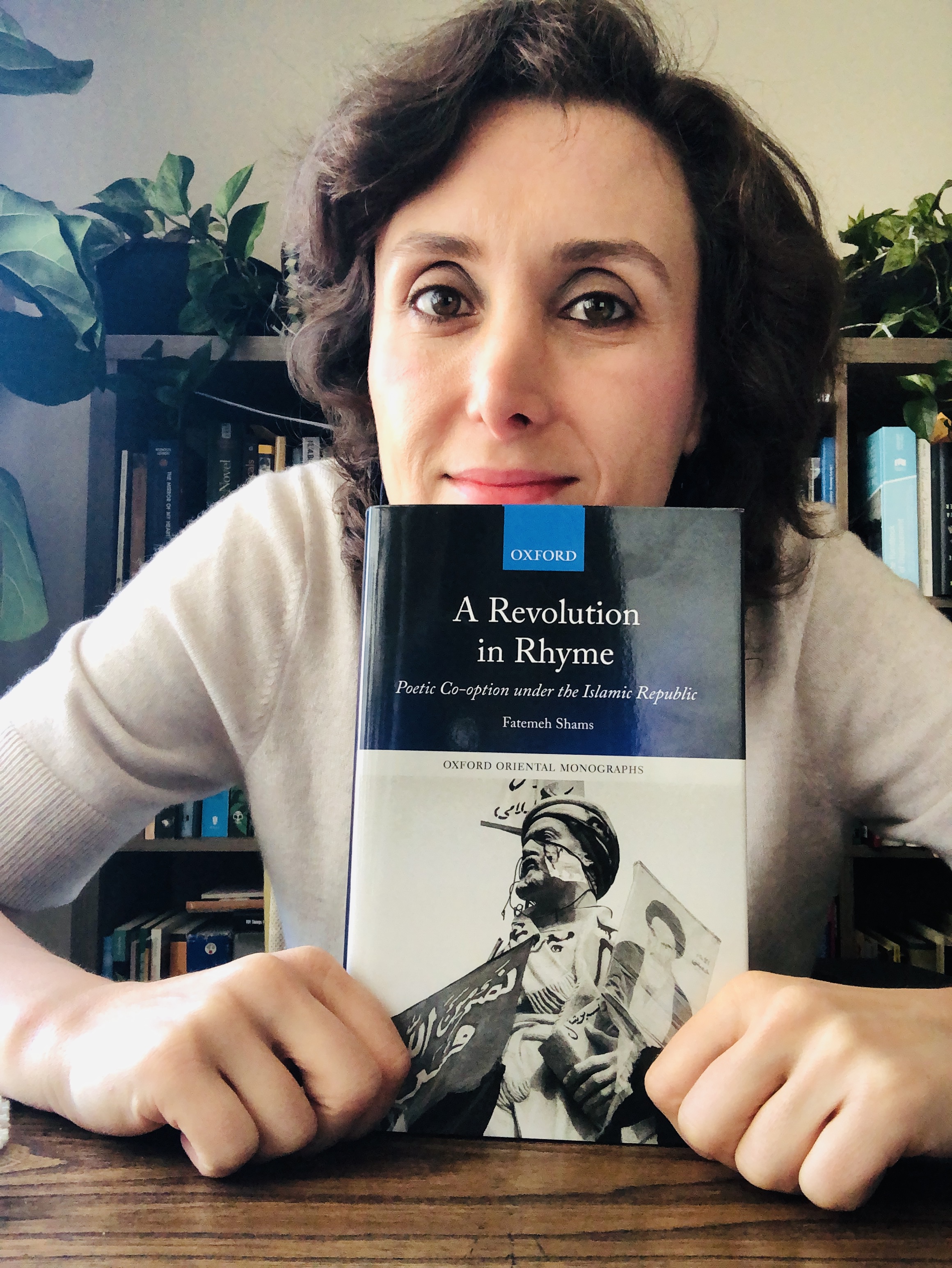 Professor holding book A Revolution in Rhyme