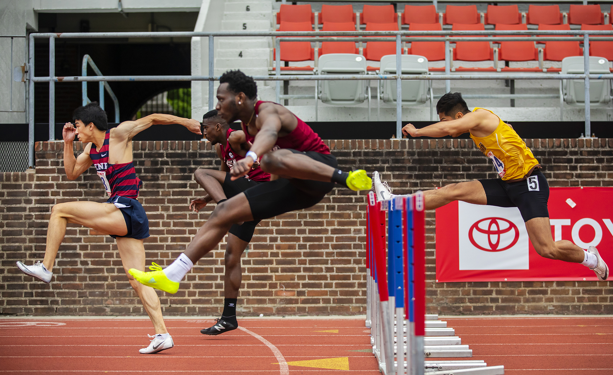 Runners jump over the hurdles at the Philadelphia Metropolitan Collegiate Invitational at Franklin Field on April 24.