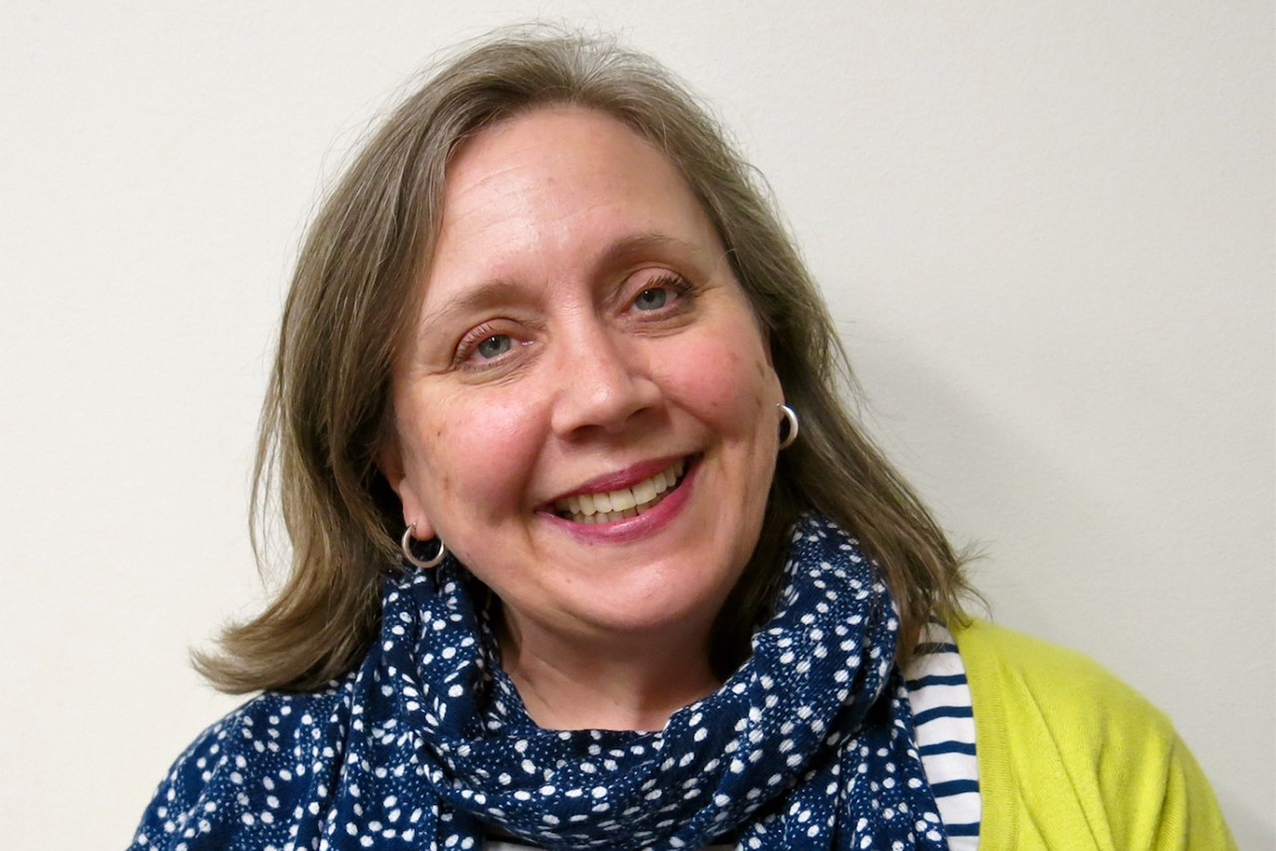 Julie Nelson Davis smiles for portrait outside her office