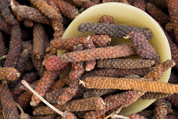 Pile of Indian long peppers.