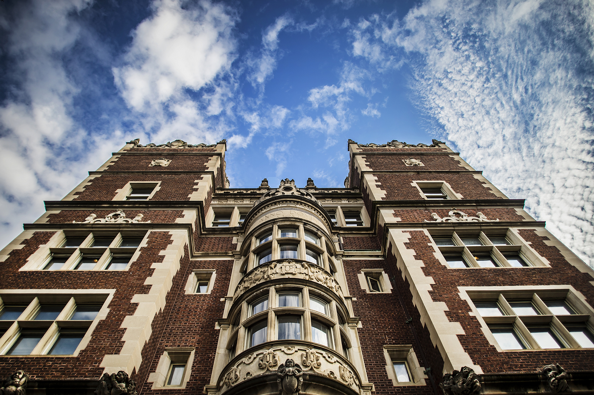 Facade of a Penn Campus building from the ground view with a blue sky.