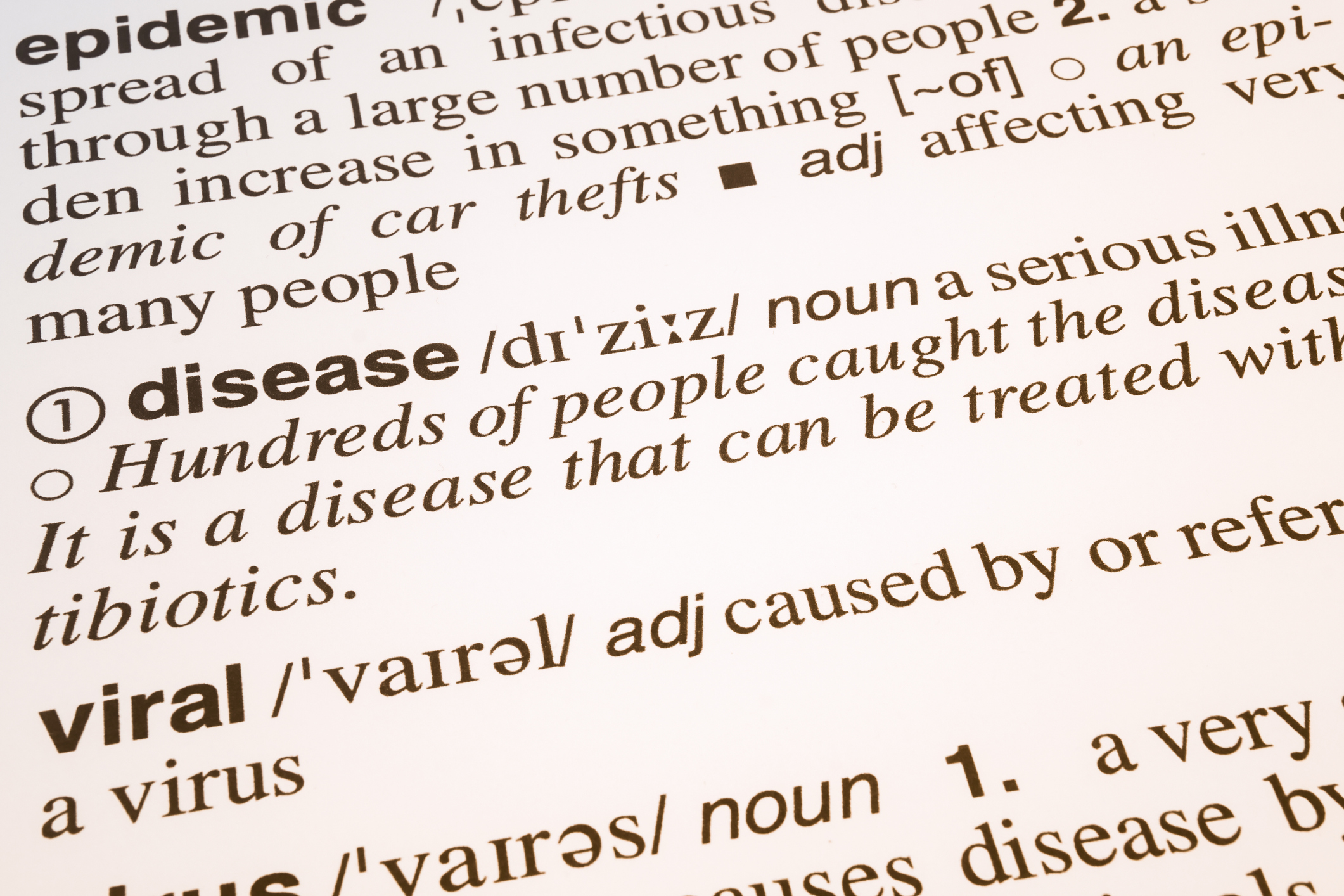a close-up of a dictionary page with definitions for the words epidemic, disease, and viral