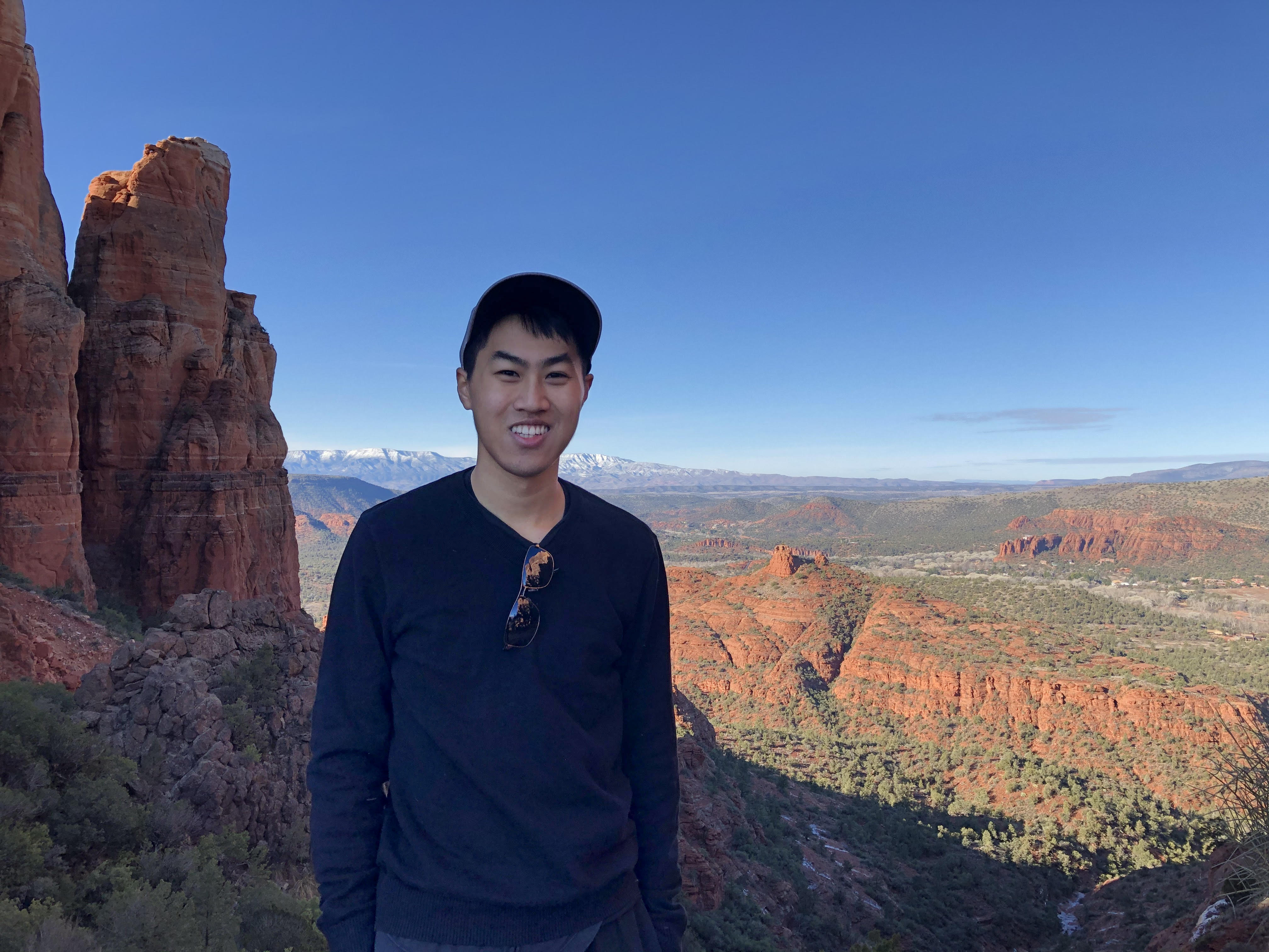 student standing outside with mountains in the background