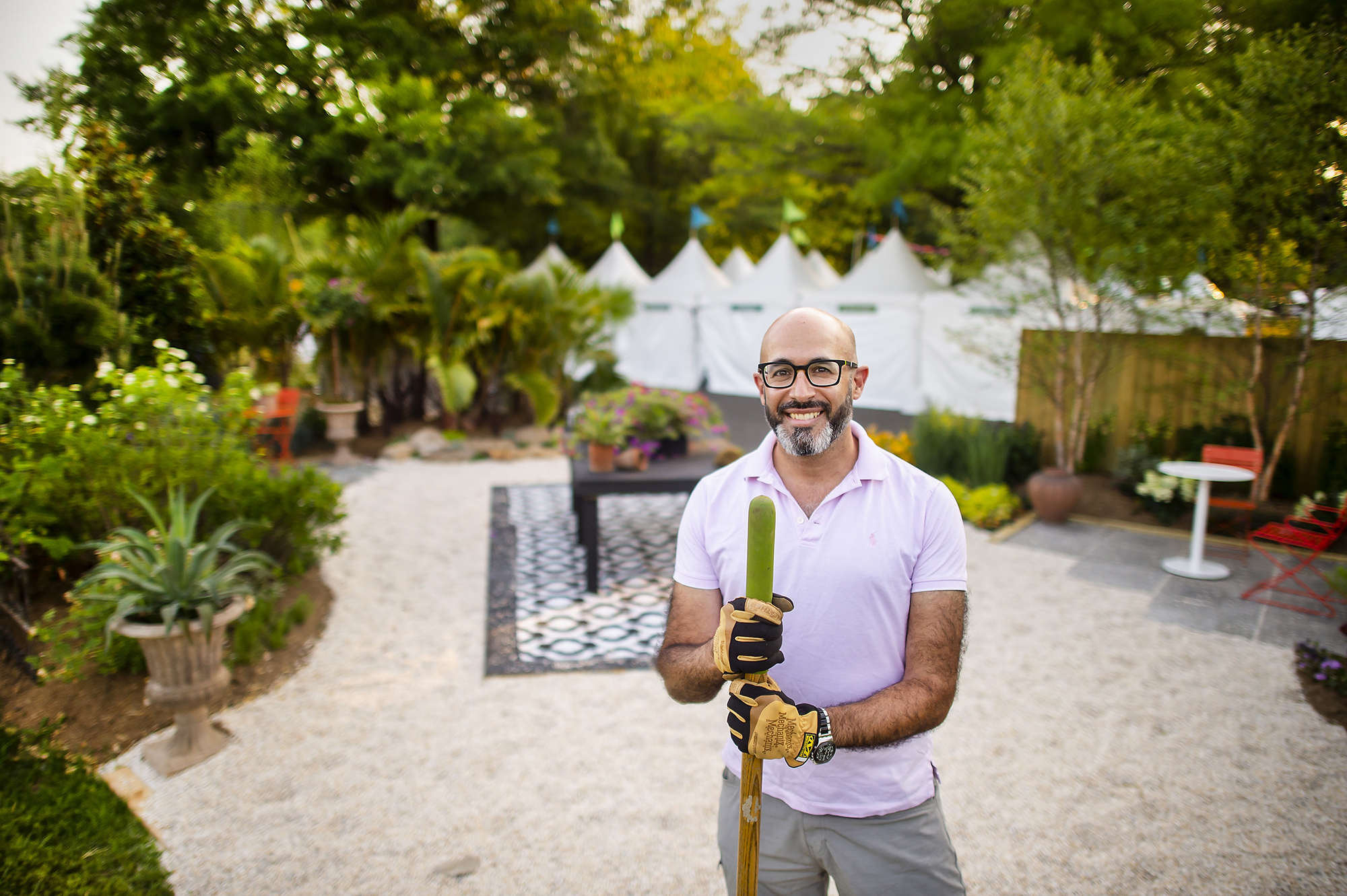 Abdallah Tabet grips rake in garden