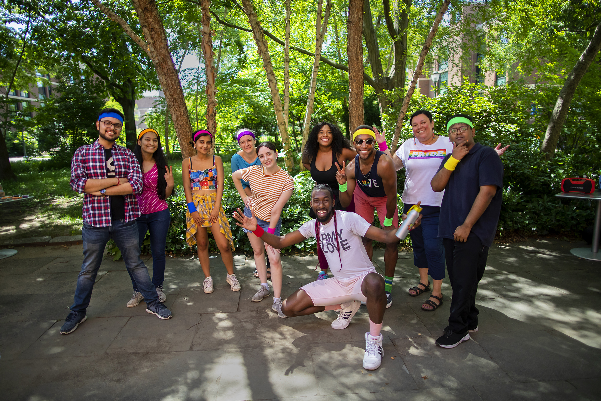 A group of people in a courtyard on Penn’s campus posing for the camera and smiling.