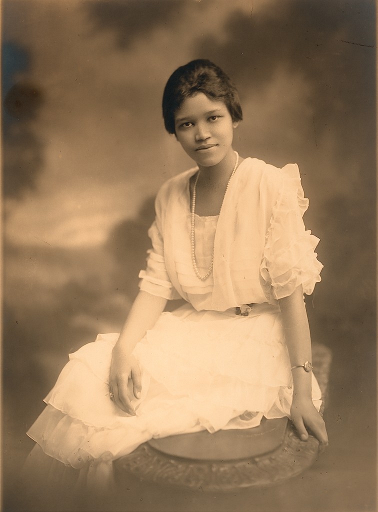 Sadie Alexander posing in white dress with pearls