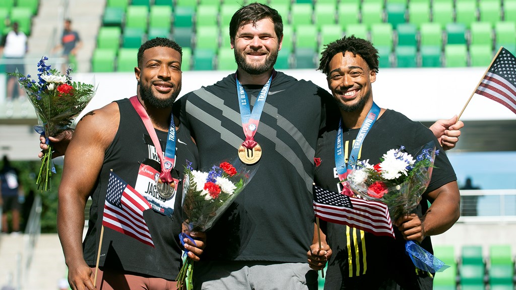 Sam Mattis, left, stands on the podium during the medal ceremony.