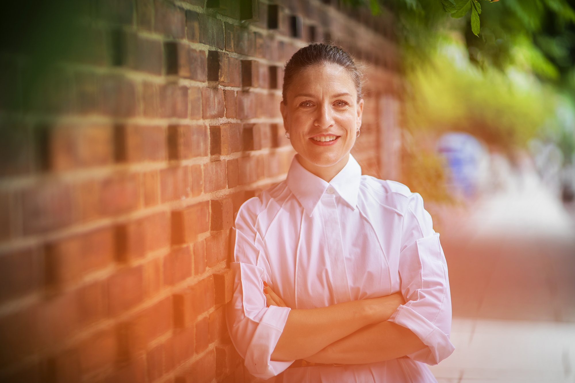 Zoë Ryan in front of brick wall